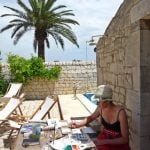 A lady painting in the shade