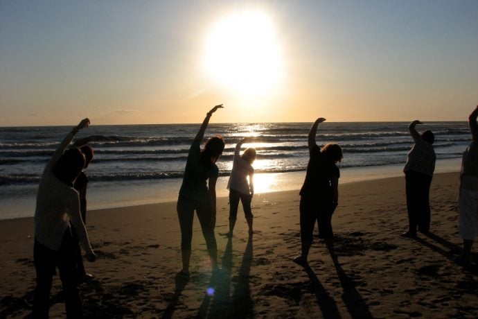 Pilates on the beach at sunset