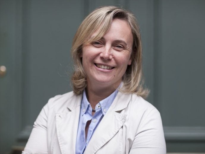 headshot of woman in front of door