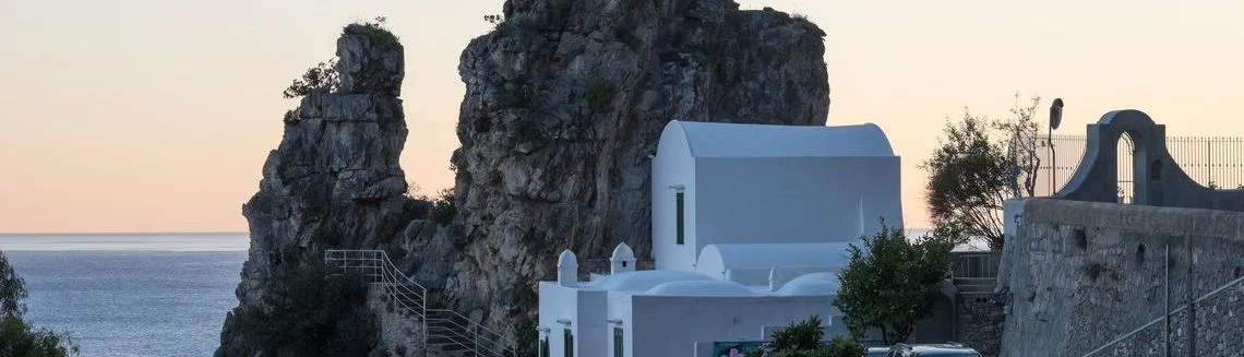 Breathtaking view of Amalfi coast and white house set on top of cliff