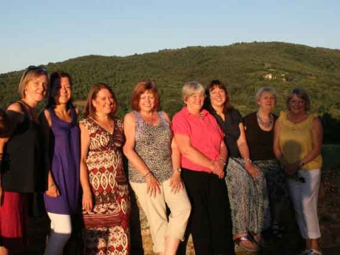 Group of guests in sunny outdoor of villa Arezzo.