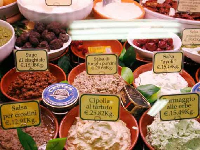 Stall of local Tuscan produce on food market in Florence.