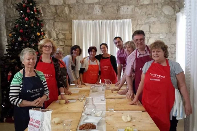 Cooks standing around a table ready for a cooking lesson