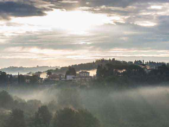 Stunning view of rural Tuscany at dusk. Stunning view of rural Tuscany, rolling hill tops and trees at dusk.