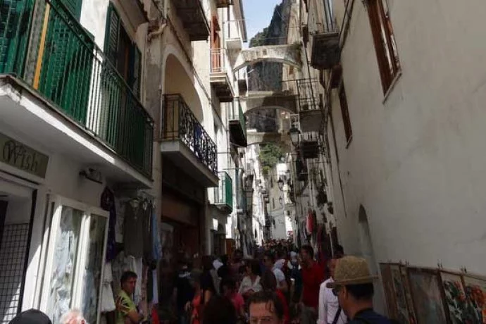 Narrow Italian streets filled with people walking up and down.