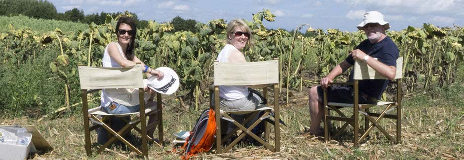 happy painting guests in tuscan fields