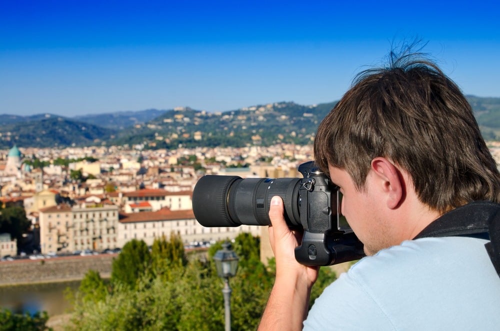 Photographer taking a picture of the scenery in Italy