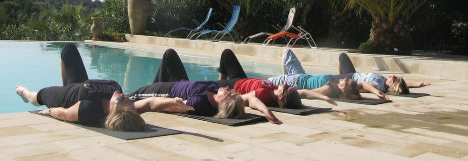 Pilates students relaxing by the pool after their Pilates holiday course