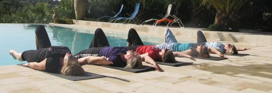 Pilates students relaxing by the pool after their Pilates holiday course
