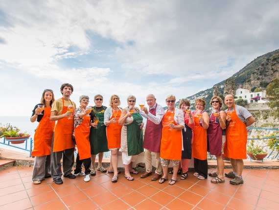 Group of single travellers raising their glasses