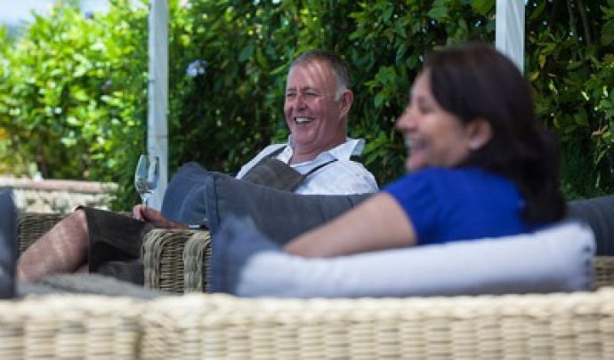 man and woman drinking prosecco and laughing