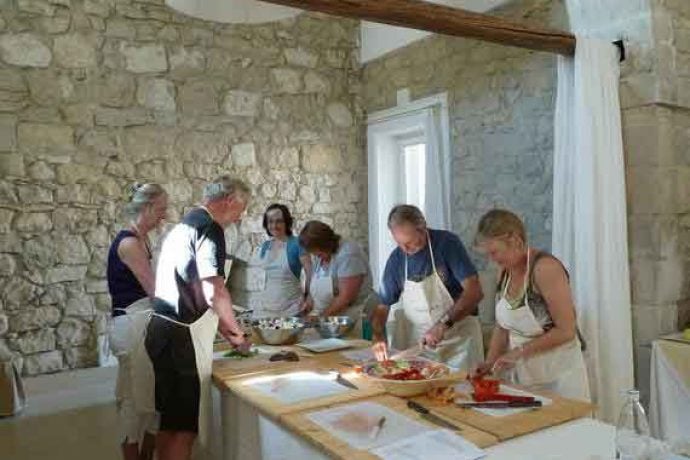 Cookery guests with chopping boards and knives.