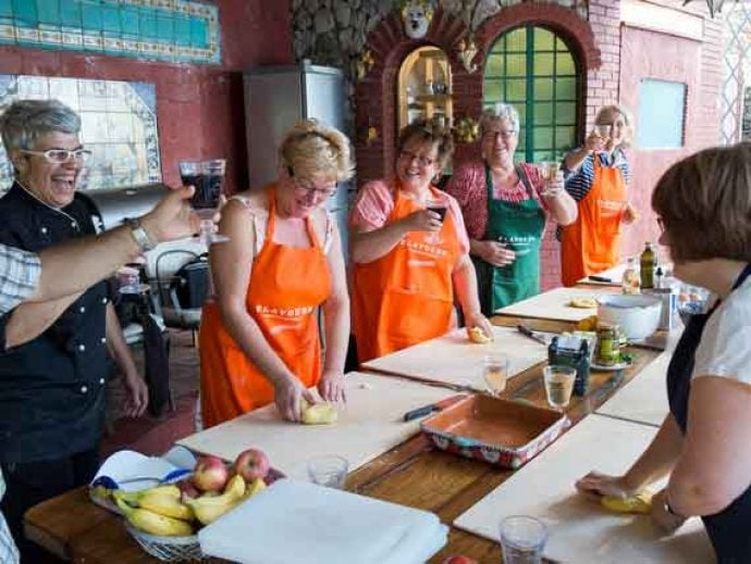 Group of people in Italian outdoor kitchen.