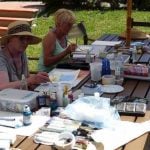 Women painting outside in the garden