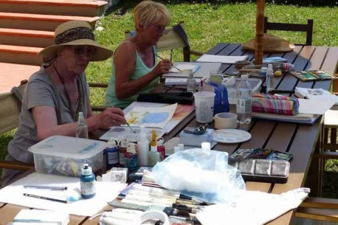 Women painting outside in the garden