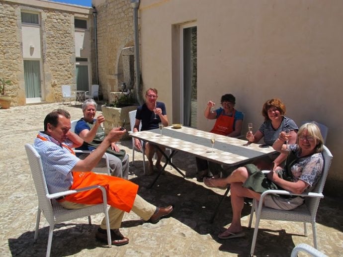 cooking guests in Sicily enjoying a glass of Prosecco