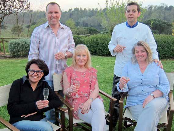 Italian chef with language guests outside drinking glass of wine