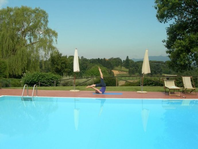 Pilates teacher doing some exercises at the pool