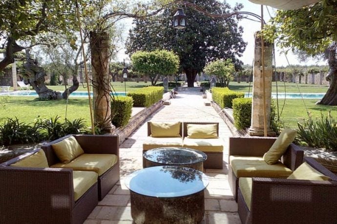 Sunny view of venue in Puglia garden and sitting area.
