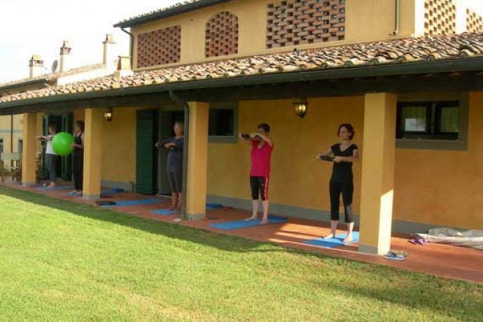 Pilates guests exercising outside Tuscan villa