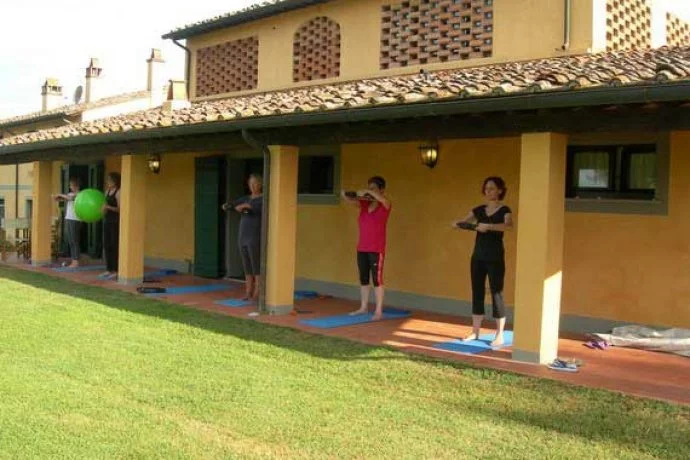 Pilates guests exercising outside Tuscan villa