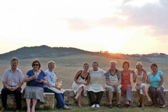 Pilates group enjoying a sunny evening outside with Italian chefs