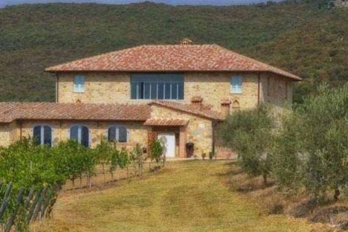 Exterior of beautiful Tuscan villa surrounded by greenery