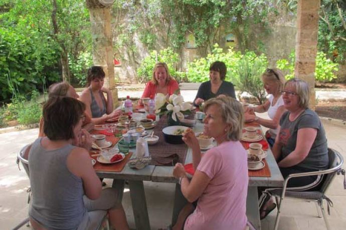Women enjoying their breakfast outdoors after their Pilates lessons
