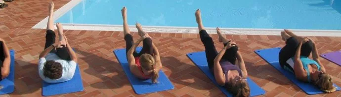 Pilates lessons by the pool at the holiday villa in Tuscany