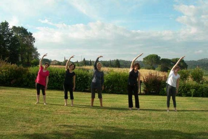 5 women doing Pilates in the Tuscan sun