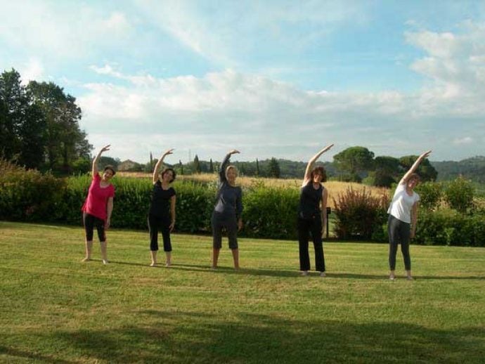 5 women doing Pilates in the Tuscan sun