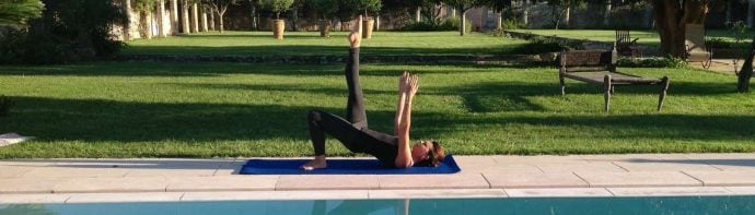 Experienced Pilates instructor doing Pilates exercise