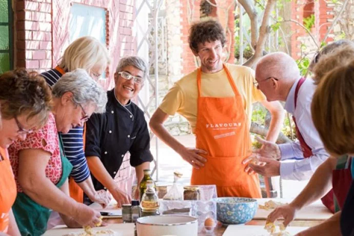 Italian chefs with cooking holiday guests in Sicily.