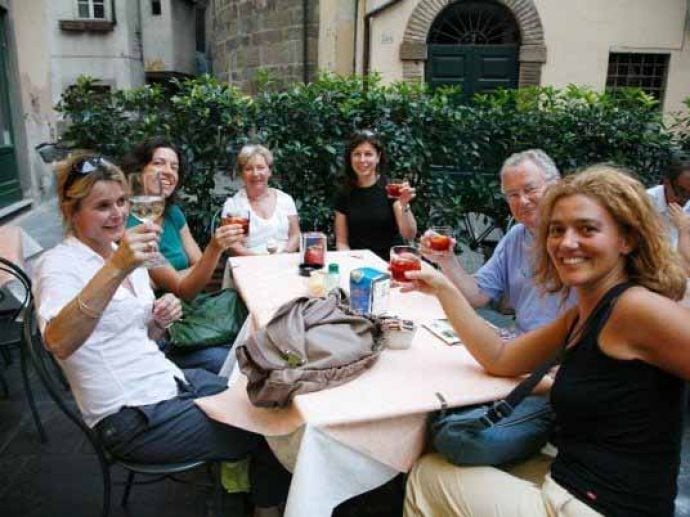 Group sitting round a table in a yard