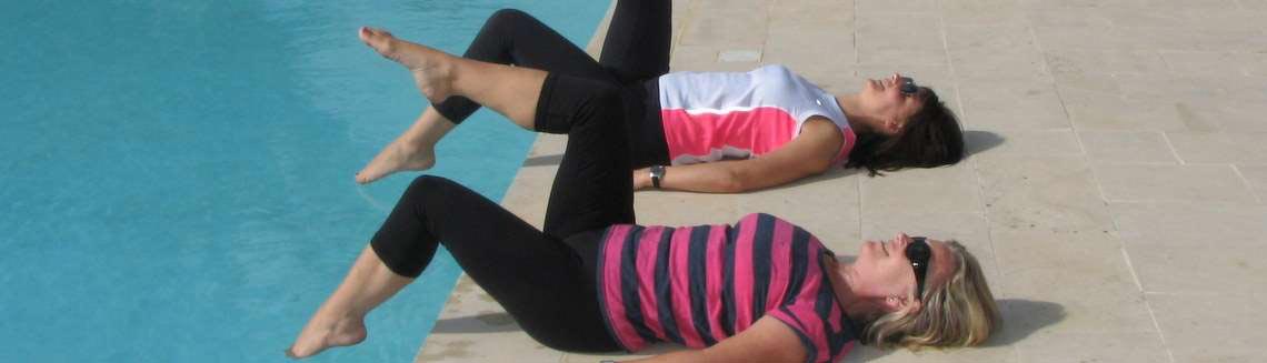 Two ladies relaxing in the sun by the pool in Sicily