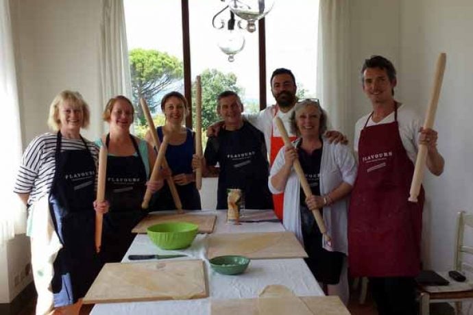Italian chef with cookery group ready to start their lesson.