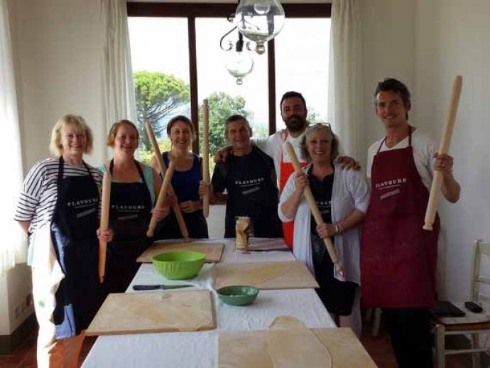Italian chef with cookery group ready to start their lesson.