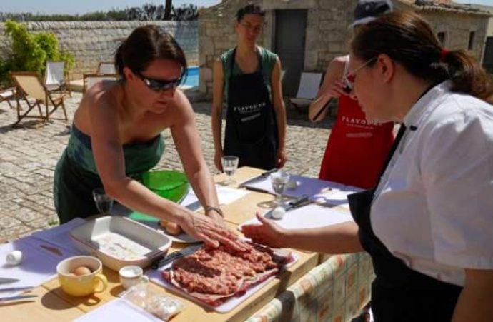 cooking group preparing dishes outside in sicily