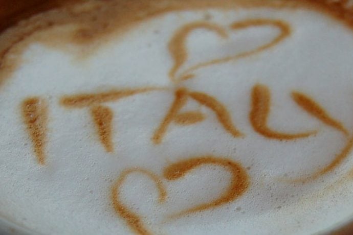 Cappuccino cup with Italy writing on it and hearts
