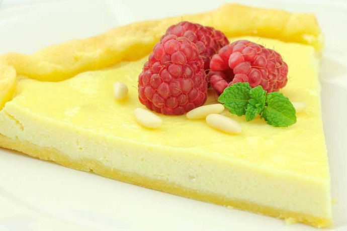 Delicious Ricotta Tart served with pine nuts and rasberries