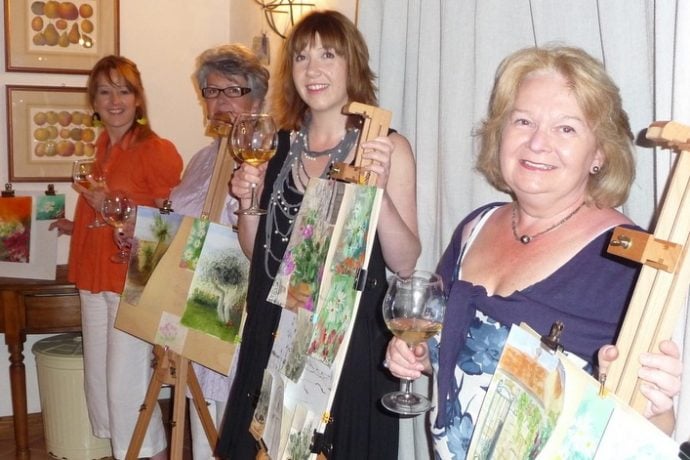 Painting guests exhibiting their art work from Italian holiday