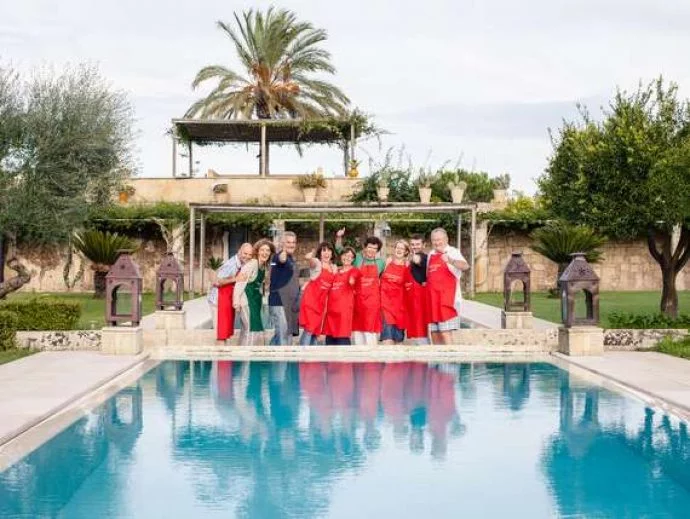 happy group of single travellers laughing outside at pool