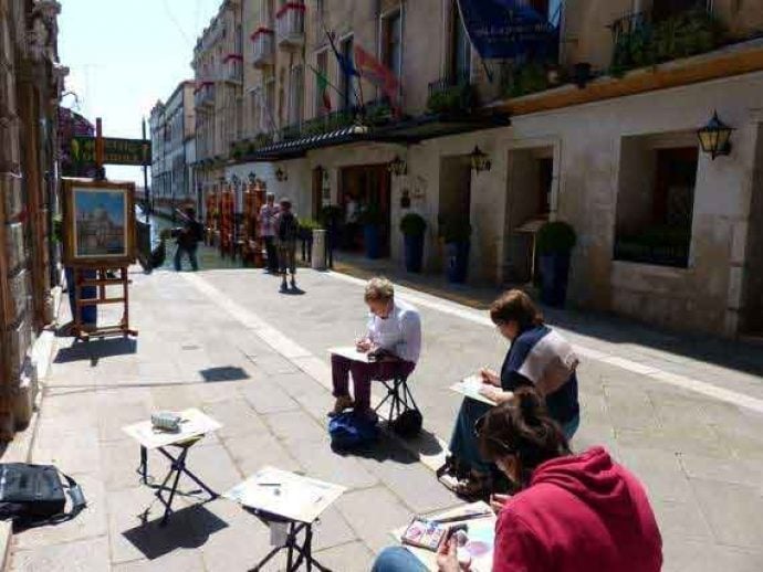 painting students outside in Venice streets with brush and easel