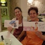 Two Italian women with aprons holding sketches from holiday