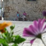 two women sketching on bench in Marzamemi Sicily