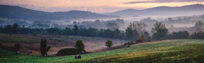 Dawn view over mist hills in Tuscany.