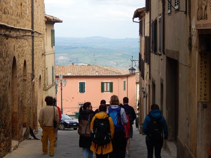 Tourists walking in Montalcino, Italy