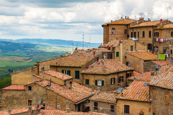 Tops of red brick buildings and terracotta roof tiles of Volterra, Tuscany