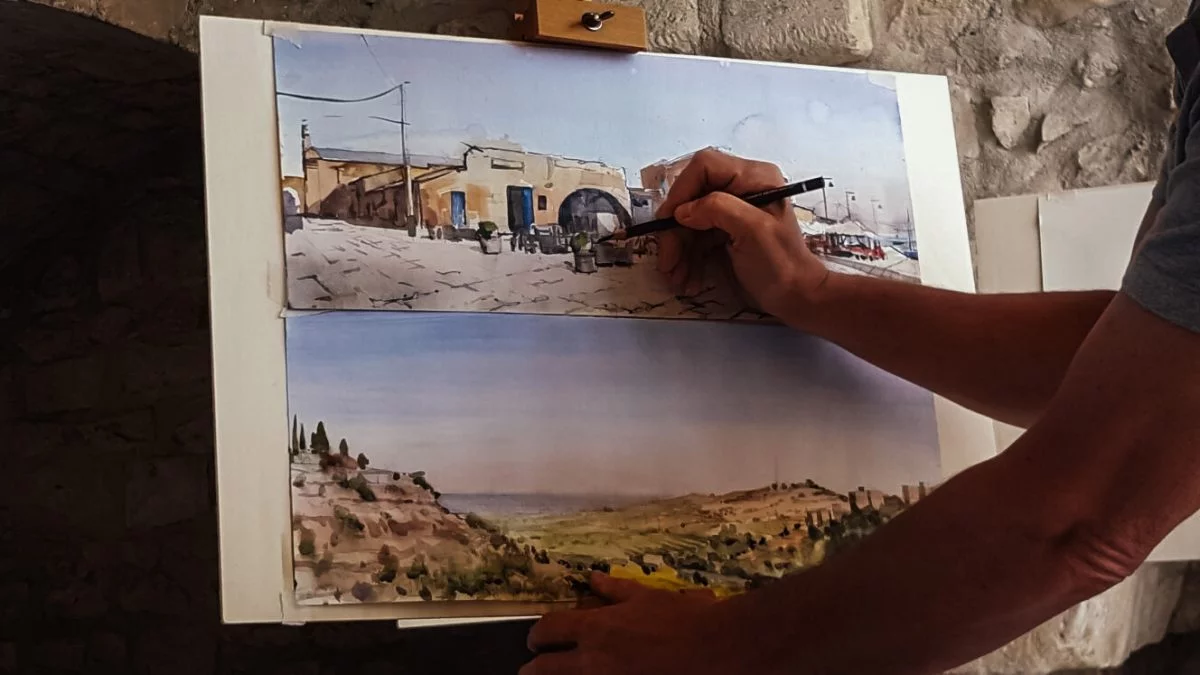 Artist puts finishing touches to landscape paintings