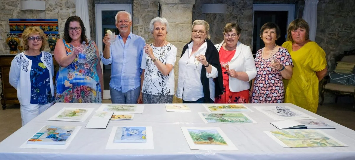 Painting group celebrating their work in Sicily